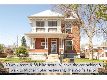 Charming two-story brick home boasts a welcoming front porch and meticulously maintained landscaping at 3905 Tejon St, Denver, CO 80211