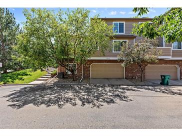Townhome boasts brick accents, attached two-car garage and mature landscaping at 6825 S Webster St # A, Littleton, CO 80128