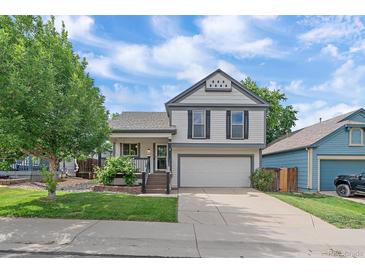 Charming two-story home with a well-manicured front yard and an attached two-car garage at 5741 E 120Th Pl, Brighton, CO 80602