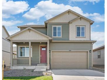 Charming two-story home featuring a covered front porch and a two car garage at 6543 13Th St, Frederick, CO 80530