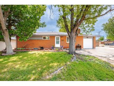 Charming brick home with mature trees and a well-manicured lawn offering great curb appeal at 6598 S Logan St, Centennial, CO 80121