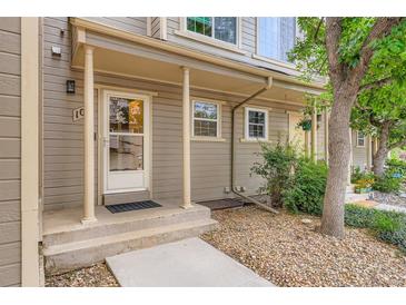 Inviting front porch featuring a concrete path leading to the front door of the two-story home at 11155 W 17Th Ave # 103, Lakewood, CO 80215