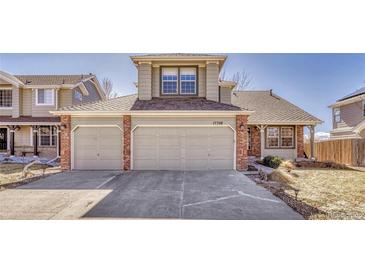 Charming home featuring a two-car garage and brick accents at 17798 E Ida Ave, Centennial, CO 80015