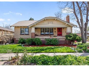 Charming brick home featuring a well-manicured front lawn and inviting red door at 3242 Utica St, Denver, CO 80212