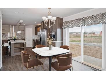 Modern kitchen with stainless steel appliances and an island at 60600 E 56Th Ave, Strasburg, CO 80136