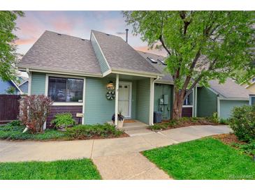 Charming home with a covered porch, landscaped front yard, and inviting curb appeal at 4877 Darwin Ct, Boulder, CO 80301