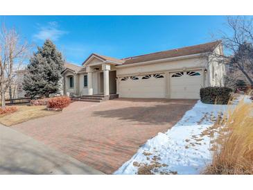 Spacious home with a three-car garage and well-maintained brick driveway in a friendly neighborhood at 6328 S Ouray Way, Aurora, CO 80016