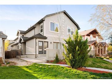 Charming two-story townhome featuring a well-maintained lawn and inviting curb appeal at 2434 S Williams St, Denver, CO 80210