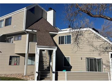 Exterior view of a two-story condo building with stairs leading to the entrance at 12484 W Nevada Pl # 210, Lakewood, CO 80228
