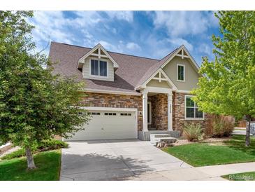 Charming two-story home with a stone facade, attached garage, and well-maintained landscaping at 23420 E Berry Ave, Aurora, CO 80016
