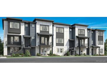 Modern townhome showcasing a sleek, contemporary design with multiple units and well-manicured landscaping at 646 Saddle Dr, Erie, CO 80516