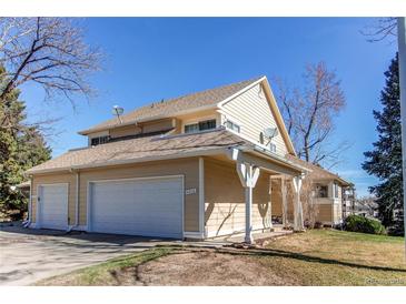 Two-story home with attached two-car garage and covered porch at 4010 S Rifle Way, Aurora, CO 80013