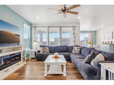 Comfortable living room featuring a plush sectional sofa and abundant natural light at 965 Peach Leaf Ln, Elizabeth, CO 80107