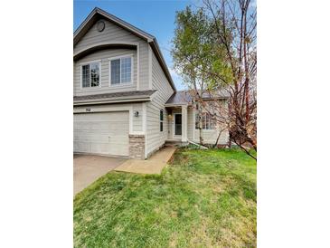 Charming two-story home featuring a well-maintained lawn and an attached two-car garage at 5521 Spruce Ave, Castle Rock, CO 80104