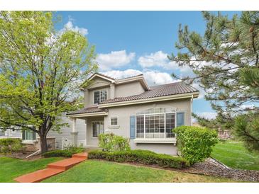 Charming two-story home with beautifully landscaped front yard and vibrant green lawn at 5129 Pasadena Way, Broomfield, CO 80023