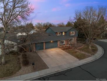 Aerial view of home showcasing its brick and siding exterior, driveway, and landscaping at 2090 S Gray Dr, Lakewood, CO 80227