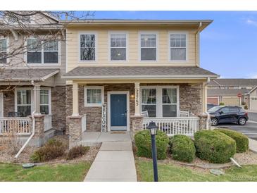 Charming two-story home with a welcoming front porch, stone accents, and well-maintained landscaping at 22765 E Ottawa Pl, Aurora, CO 80016