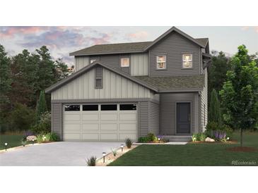 Charming two-story home with gray siding, attached garage, and manicured lawn and landscaped walkway at 18978 E 94Th Pl, Commerce City, CO 80022
