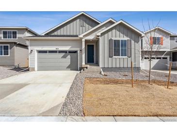 Charming single Gathering home featuring neutral siding, an attached garage, and front yard in a suburban neighborhood at 9112 Telluride Ct, Commerce City, CO 80022