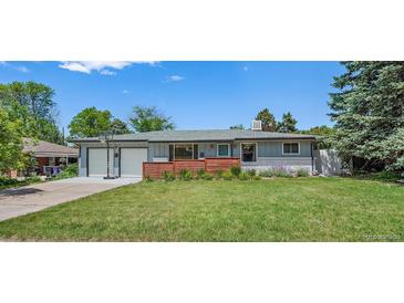 Charming home with well-maintained front yard, lovely landscaping, and attached two-car garage at 4855 E Atlantic Pl, Denver, CO 80222
