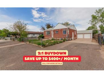 Charming brick home featuring a well-maintained front yard and a detached two-car garage at 8110 Ivy St, Commerce City, CO 80022
