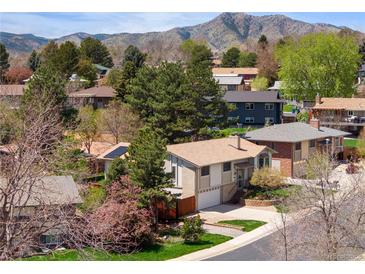 Charming home nestled in a tree-filled neighborhood with mountain views at 12662 W Asbury Pl, Lakewood, CO 80228