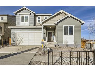 Charming two-story home featuring a two car garage, inviting entrance, and tasteful landscaping at 4096 Estrella St, Brighton, CO 80601