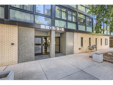 Condo building exterior showcasing the entrance and landscaping at 1050 N Corona St # 207, Denver, CO 80218