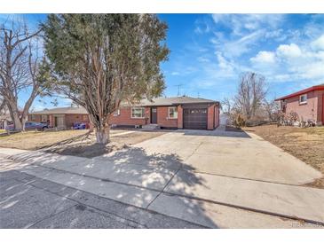 Charming brick home with a well-maintained lawn, mature trees and a two car garage at 3272 W Stanford W Ave, Englewood, CO 80110