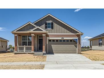 Charming single-Gathering home showcasing a welcoming porch and a spacious two-car garage in a suburban neighborhood at 5165 N Quemoy St, Aurora, CO 80019