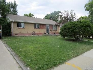 Charming ranch-style home with a brick exterior and well-maintained front yard at 5640 E 67Th Pl, Commerce City, CO 80022