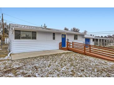 Single-story home with white siding, blue front door, and ramp access at 621 Campo St, Denver, CO 80221