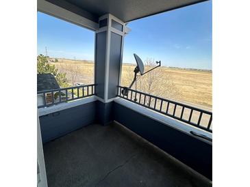View from balcony showcasing a large open space with a home and satellite dish at 5255 Memphis St # 121, Denver, CO 80239