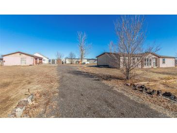 Spacious property with a long driveway, detached garage, and two mobile homes at 501 Zante Way, Lochbuie, CO 80603