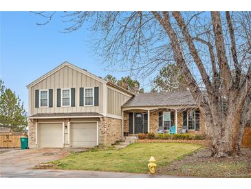 Charming two-story home featuring a two-car garage and a welcoming front porch at 15865 E Kepner Dr, Aurora, CO 80017