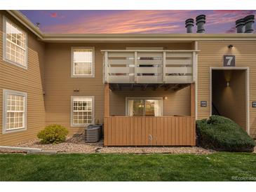 A charming condo exterior with a private patio area and balcony under a beautiful sunset sky at 10251 W 44Th Ave # 7-106, Wheat Ridge, CO 80033