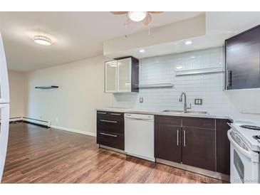 Modern kitchen with stainless steel appliances and beautiful backsplash at 13691 E Marina Dr # 107, Aurora, CO 80014