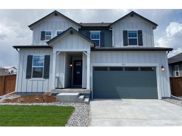 Charming two-story home with a two-car garage, covered porch and classic architectural details at 2177 Garden Ave, Brighton, CO 80601