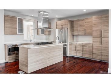 Modern kitchen features light wood cabinets, stainless steel appliances, and island cooktop at 3619 Navajo St, Denver, CO 80211
