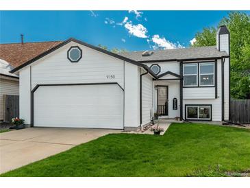 Charming two-story home featuring a white exterior, well-manicured lawn, and attached two-car garage at 9150 W 94Th Ave, Westminster, CO 80021