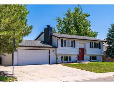 Charming two-story home with a freshly painted white exterior and a neatly maintained front lawn at 9410 Perry St, Westminster, CO 80031