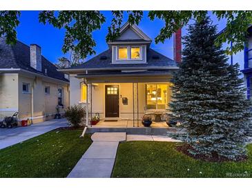 Charming home featuring a covered front porch, manicured lawn, and classic architectural details, perfect for curb appeal at 340 S Logan St, Denver, CO 80209