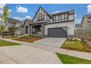 Stunning two-story home featuring a gray facade, well-manicured lawn, and an attached two-car garage at 1846 Chestnut Ave, Erie, CO 80516