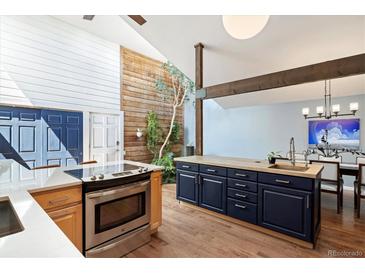 Bright kitchen featuring an indoor courtyard with a wooden accent wall and modern appliances at 6305 W 6Th Ave # C12, Lakewood, CO 80214