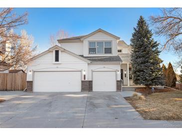 Charming two-story home featuring a three car garage, covered porch, and well-maintained landscaping at 8369 W Fairview Ave, Littleton, CO 80128