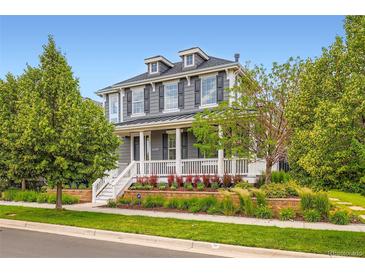 Charming two-story home with a welcoming front porch and professionally landscaped yard at 3597 Xanthia St, Denver, CO 80238
