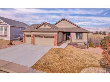 Well-maintained ranch-style home featuring a three-car garage and a beautifully landscaped front yard at 1339 Bent Grass Cir, Castle Rock, CO 80109