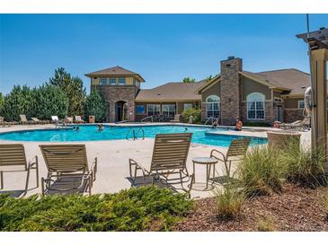 Beautiful community pool with lounge chairs and seating area perfect for relaxing and enjoying the summer weather at 3100 Blue Sky Cir # 205, Erie, CO 80516