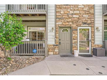 A welcoming front entrance with stone accents, a covered porch, and a well-maintained walkway at 3262 E 103Rd Dr # 1810, Thornton, CO 80229
