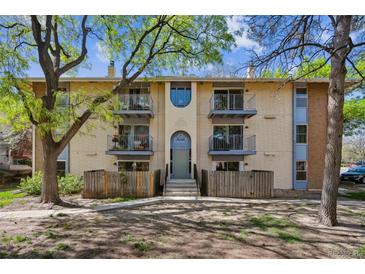 Two-story apartment building featuring four balconies, neutral paint, and a well-kept lawn at 12108 Melody Dr # 103, Denver, CO 80234